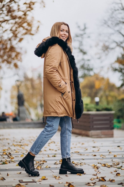 Free photo young woman wearing jacket walking outside