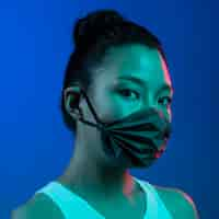 Free photo young woman wearing mask