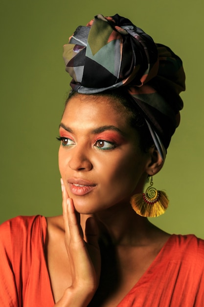 Young woman wearing orange dress with turban and ethnic jewelry