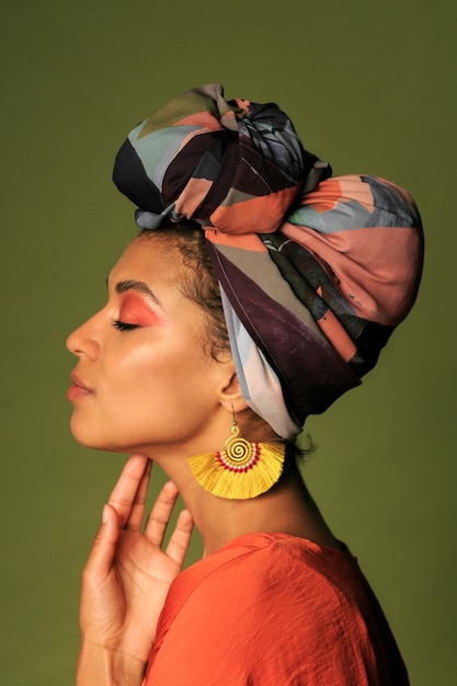 Young woman wearing orange dress with turban and ethnic jewelry