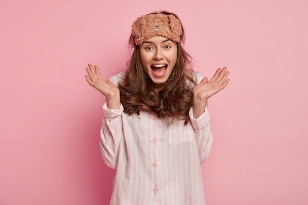 Young woman wearing pajamas and sleep mask