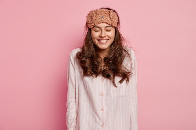 Young woman wearing pajamas and sleep mask