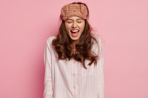 Young woman wearing pajamas and sleep mask