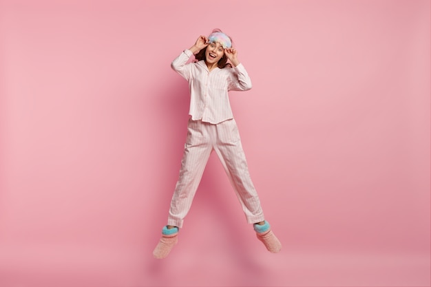 Young woman wearing pajamas and sleep mask