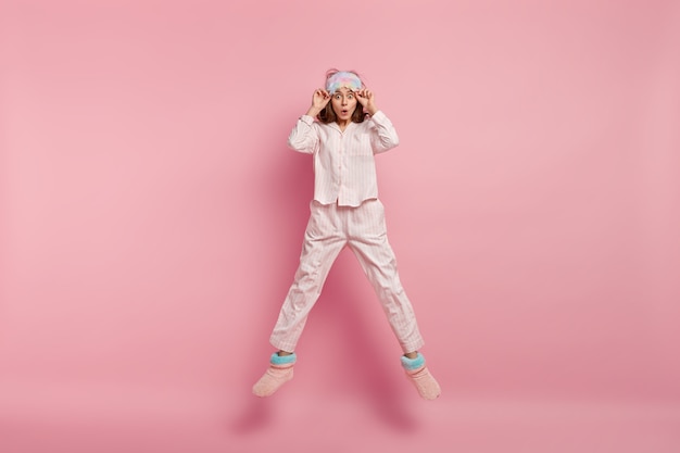 Young woman wearing pajamas and sleep mask