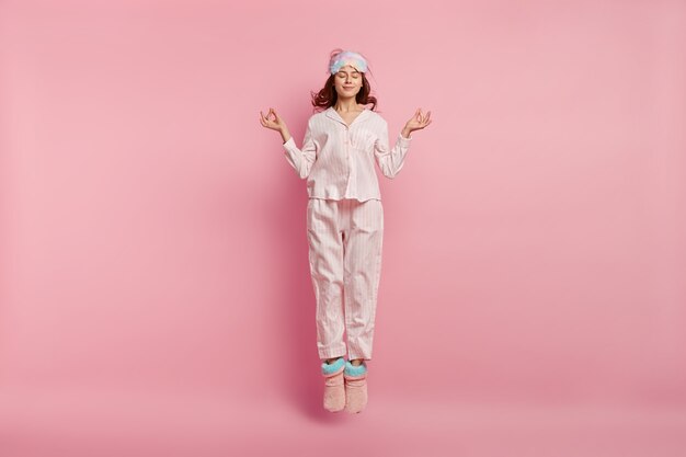 Young woman wearing pajamas and sleep mask
