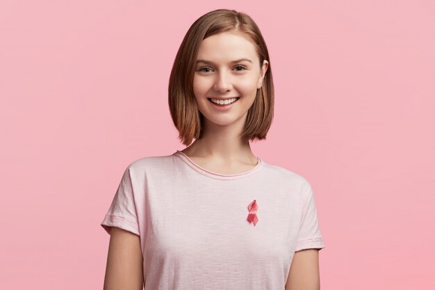 Young woman wearing pink breast cancer awareness ribbon