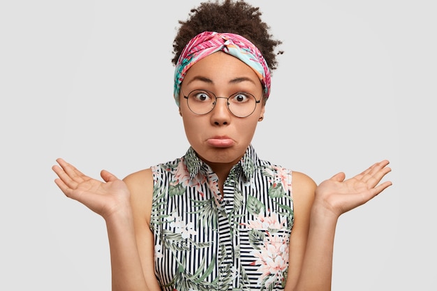 Young woman wearing round eyeglasses and colorful bandana