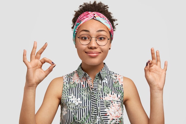 Young woman wearing round eyeglasses and colorful bandana