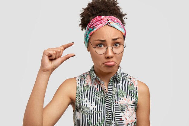 Young woman wearing round eyeglasses and colorful bandana