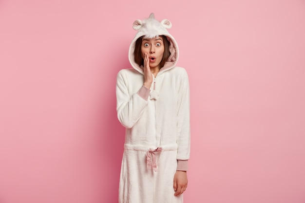 Free photo young woman wearing unicorn pajamas