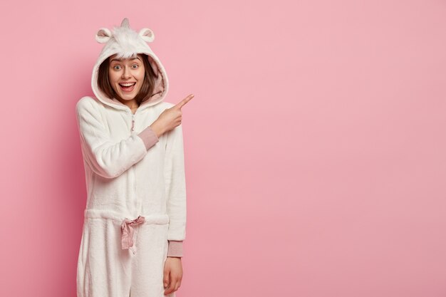 Young woman wearing unicorn pajamas