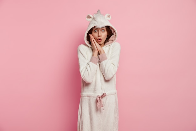 Free photo young woman wearing unicorn pajamas