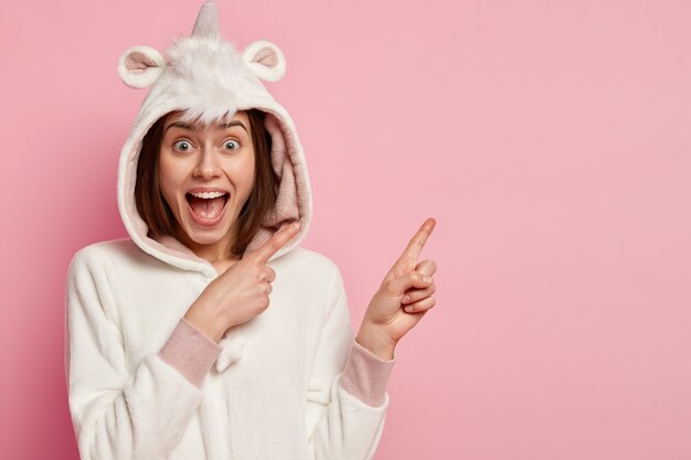 Young woman wearing unicorn pajamas