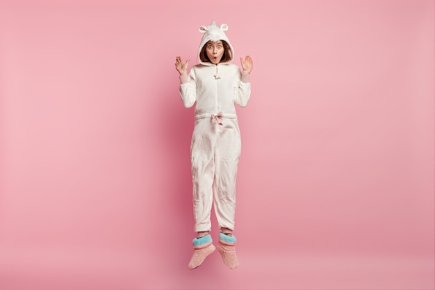 Young woman wearing unicorn pajamas