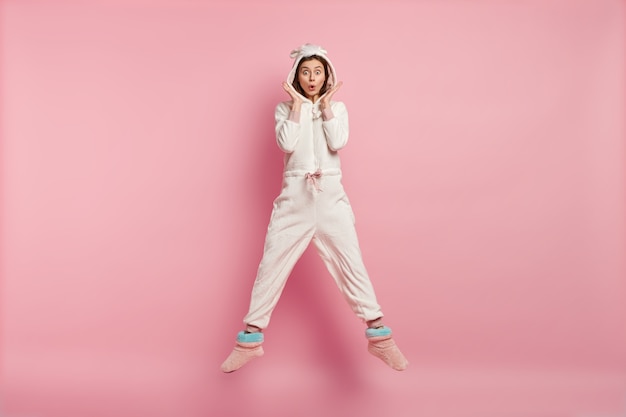 Young woman wearing unicorn pajamas