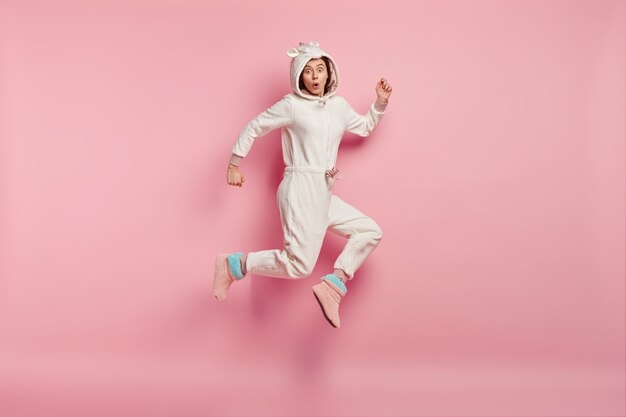 Young woman wearing unicorn pajamas