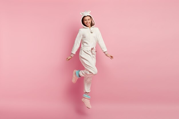 Young woman wearing unicorn pajamas