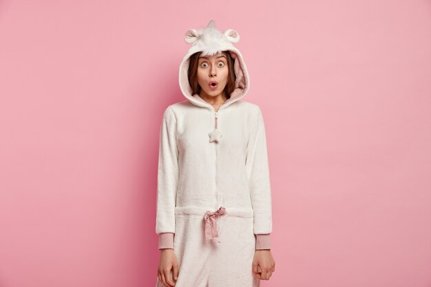 Free photo young woman wearing unicorn pajamas