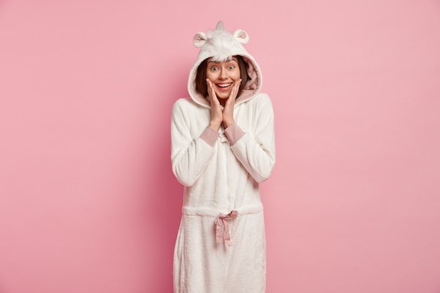 Young woman wearing unicorn pajamas