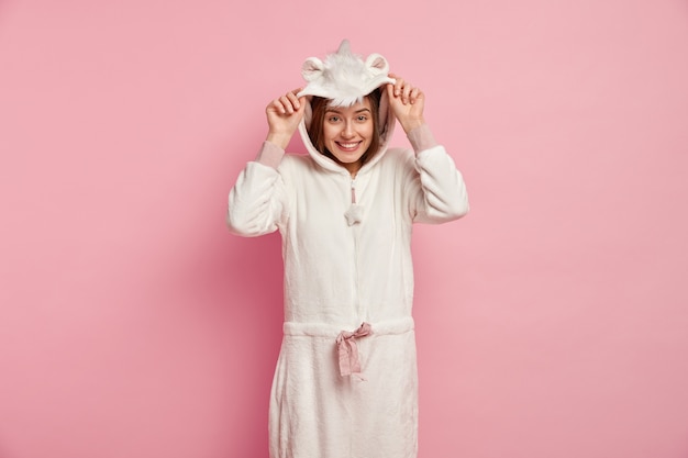 Free photo young woman wearing unicorn pajamas