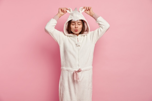 Young woman wearing unicorn pajamas