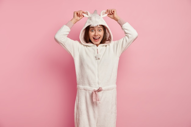 Free photo young woman wearing unicorn pajamas