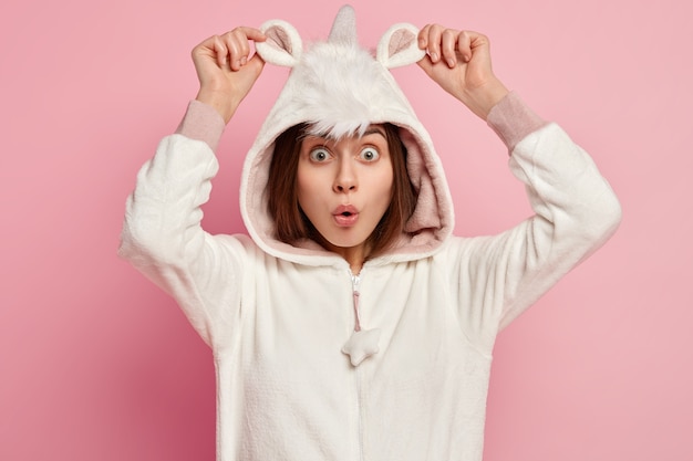 Young woman wearing unicorn pajamas