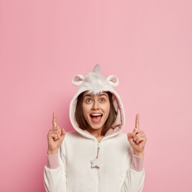 Young woman wearing unicorn pajamas