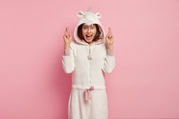 Free photo young woman wearing unicorn pajamas