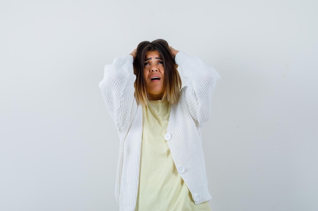 Free photo young woman wearing a white cardigan being stressed