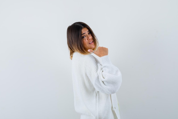 Young woman wearing a white cardigan