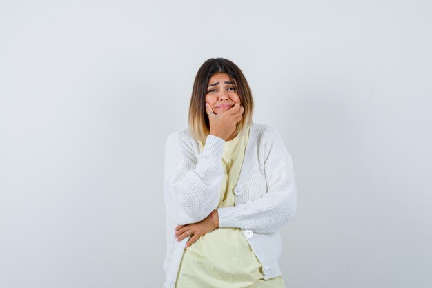 Young woman wearing a white cardigan