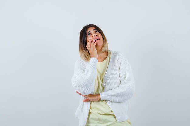 Young woman wearing a white cardigan