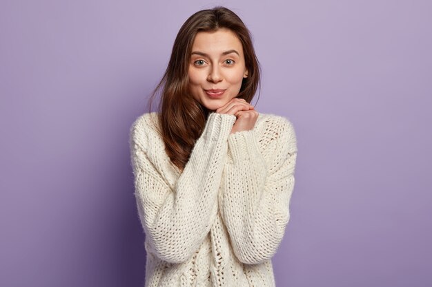 Young woman wearing white sweater