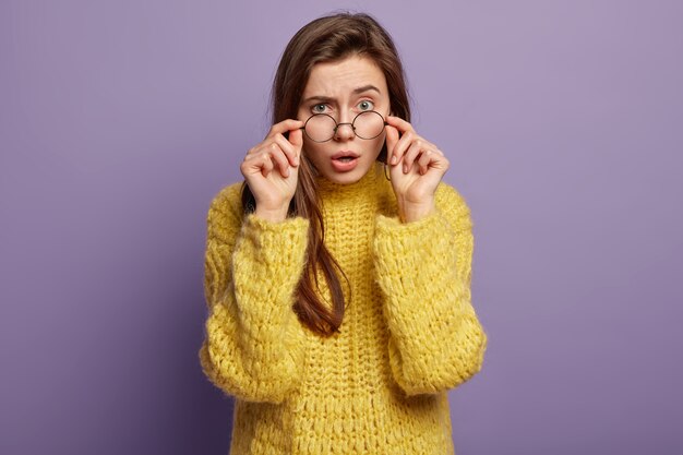 Young woman wearing yellow sweater