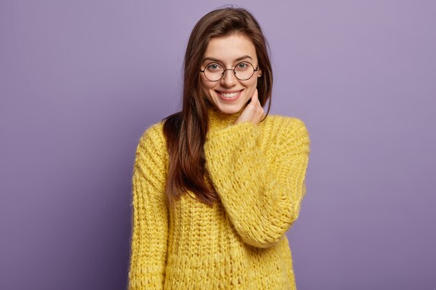 Young woman wearing yellow sweater