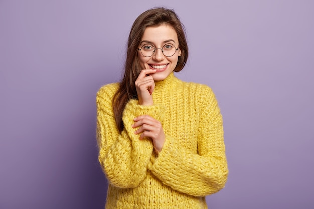 Young woman wearing yellow sweater