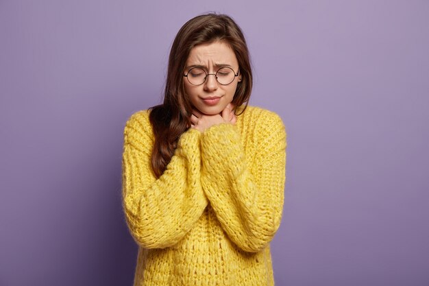 Young woman wearing yellow sweater