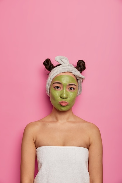 Free photo young woman wears natural facial mask skin treatments after taking bath