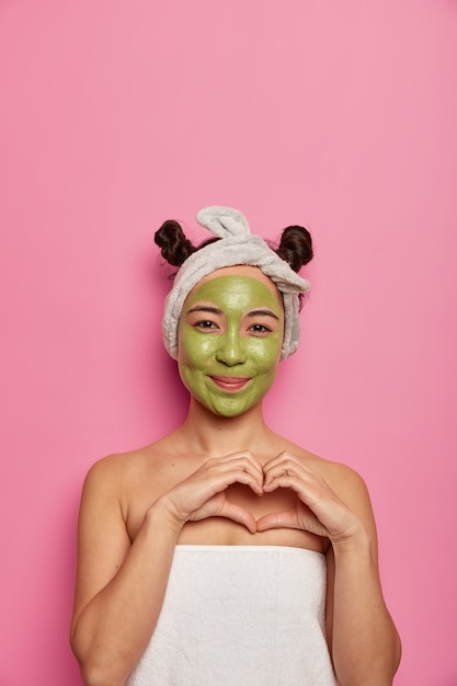 Free photo young woman wears natural facial mask skin treatments after taking bath