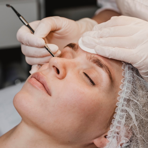 Free photo young woman at the wellness center during a skin treatment