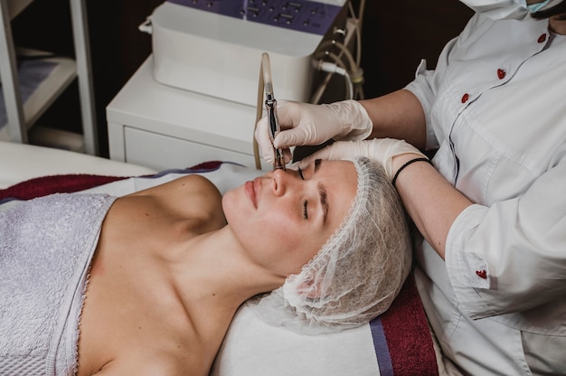 Young woman at the wellness center having a cosmetic treatment