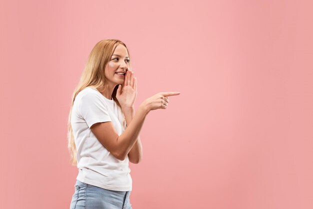 Free photo the young woman whispering a secret behind her hand