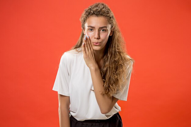 The young woman whispering a secret behind her hand