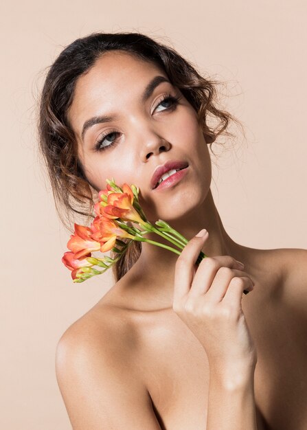 Young woman wih bright colored flowers portrait