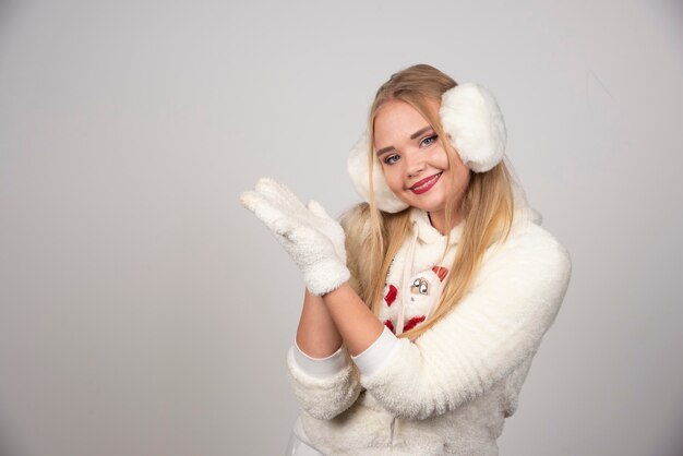 Young woman in winter outfit looking peaceful.