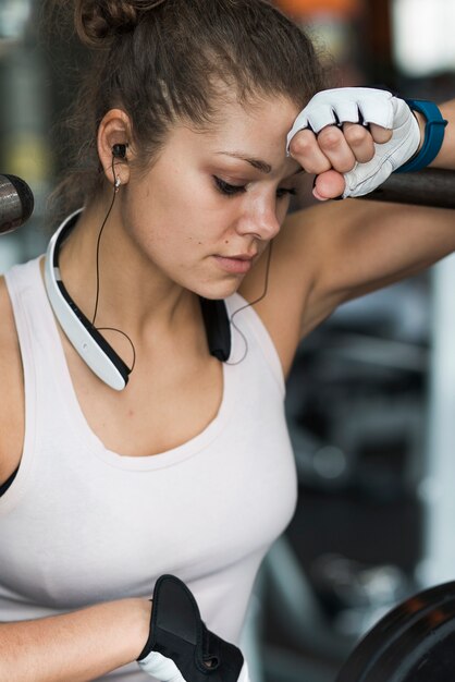 Young woman wiping sweat from forehead