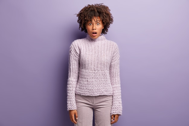 Young woman with Afro haircut wearing purple sweater