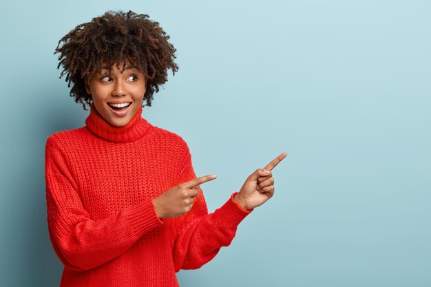 Young woman with Afro haircut wearing red sweater